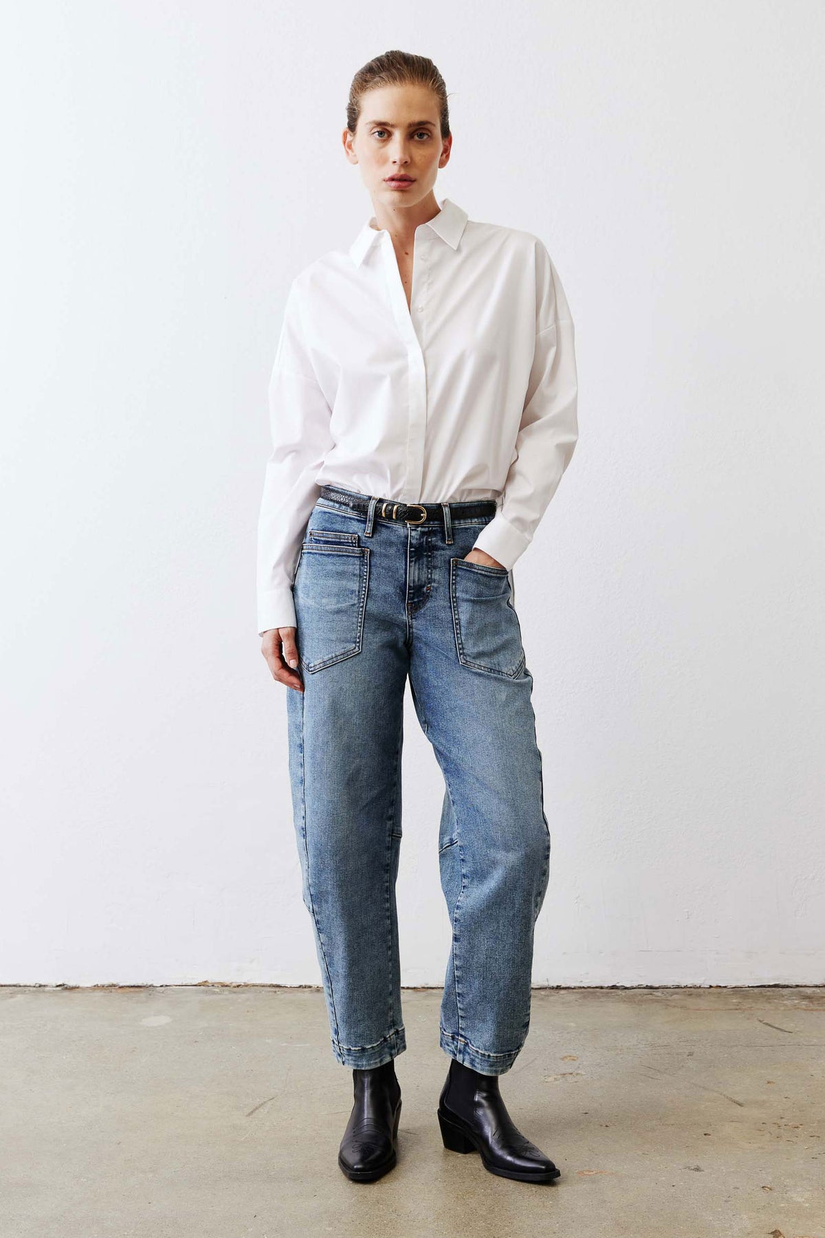 White oversized tunic shirt with point collar, button placket, and long sleeves