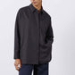 Black oversized tunic shirt with button-front, pointed collar, long sleeves