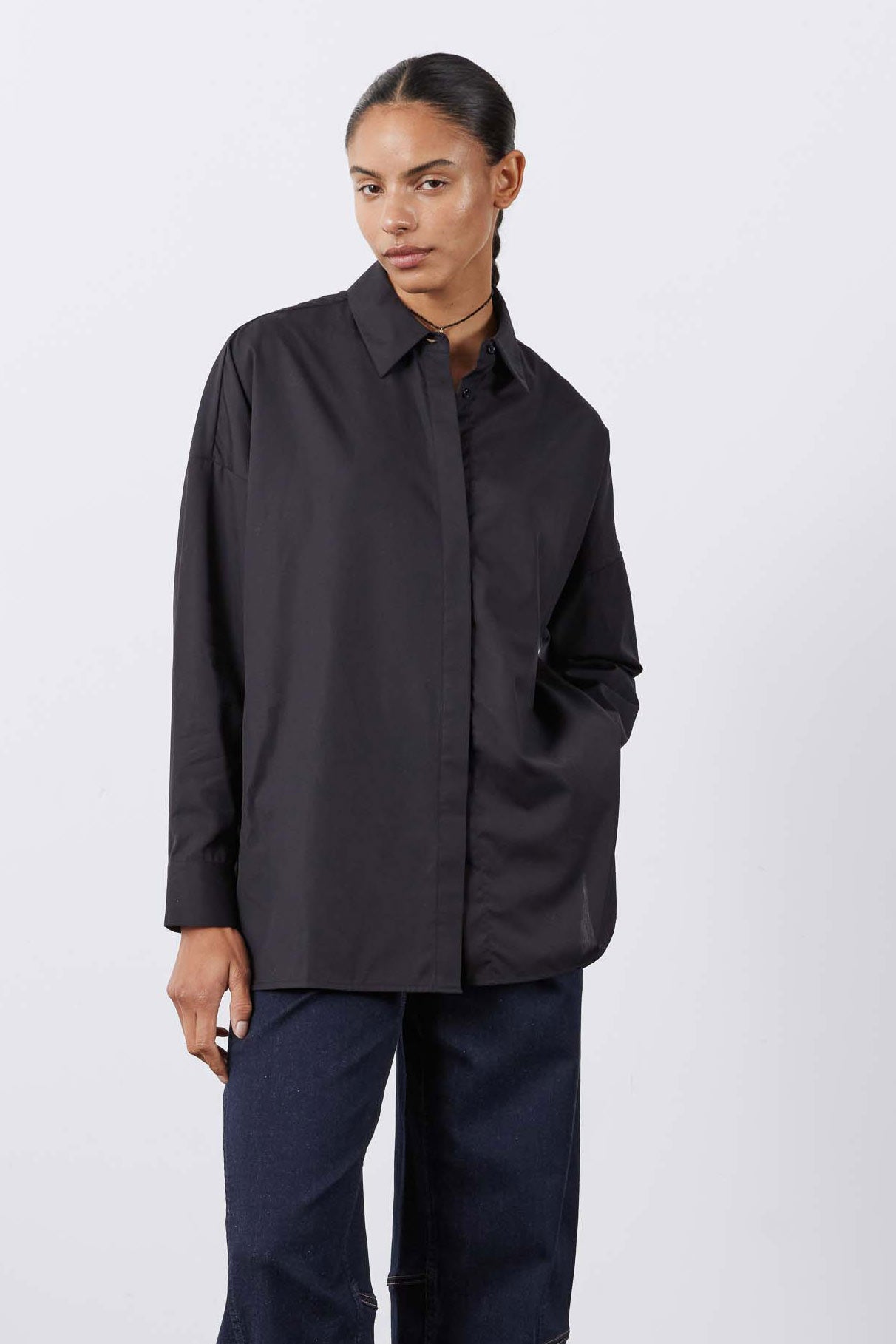 Black oversized tunic shirt with button-front, pointed collar, long sleeves