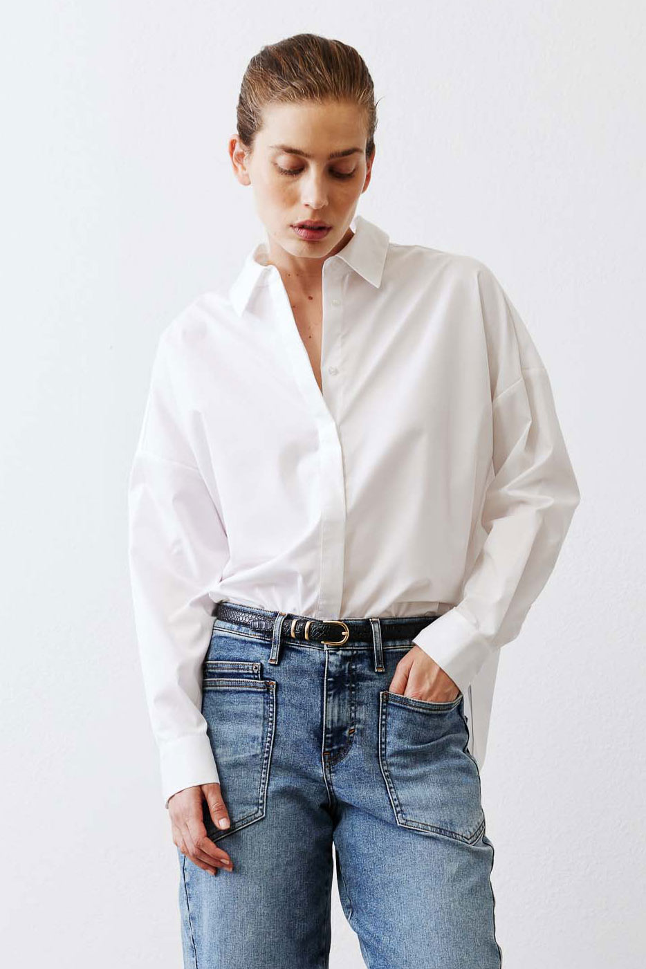 White oversized tunic shirt with slightly open point collar and long button sleeves