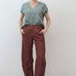 Spice brown loose linen pants front view with button placket, belt loops, and pockets