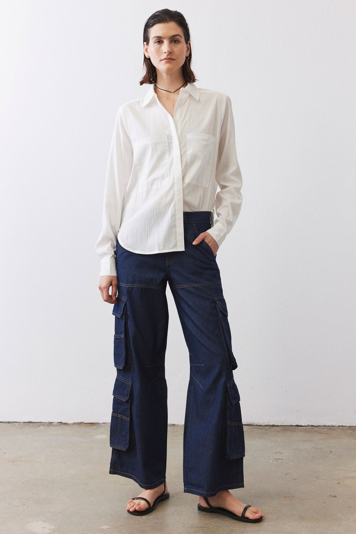 Petite dark-wash denim cargo pants with patch pockets and wide straight-leg fit