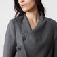 Gray pinstripe asymmetric suit jacket close-up with double-breasted placket and collar