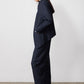 Navy pinstripe asymmetric suit jacket, side view, angled hem, long sleeves