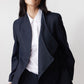 Navy pinstripe asymmetric suit jacket with draped lapel and button placket detail