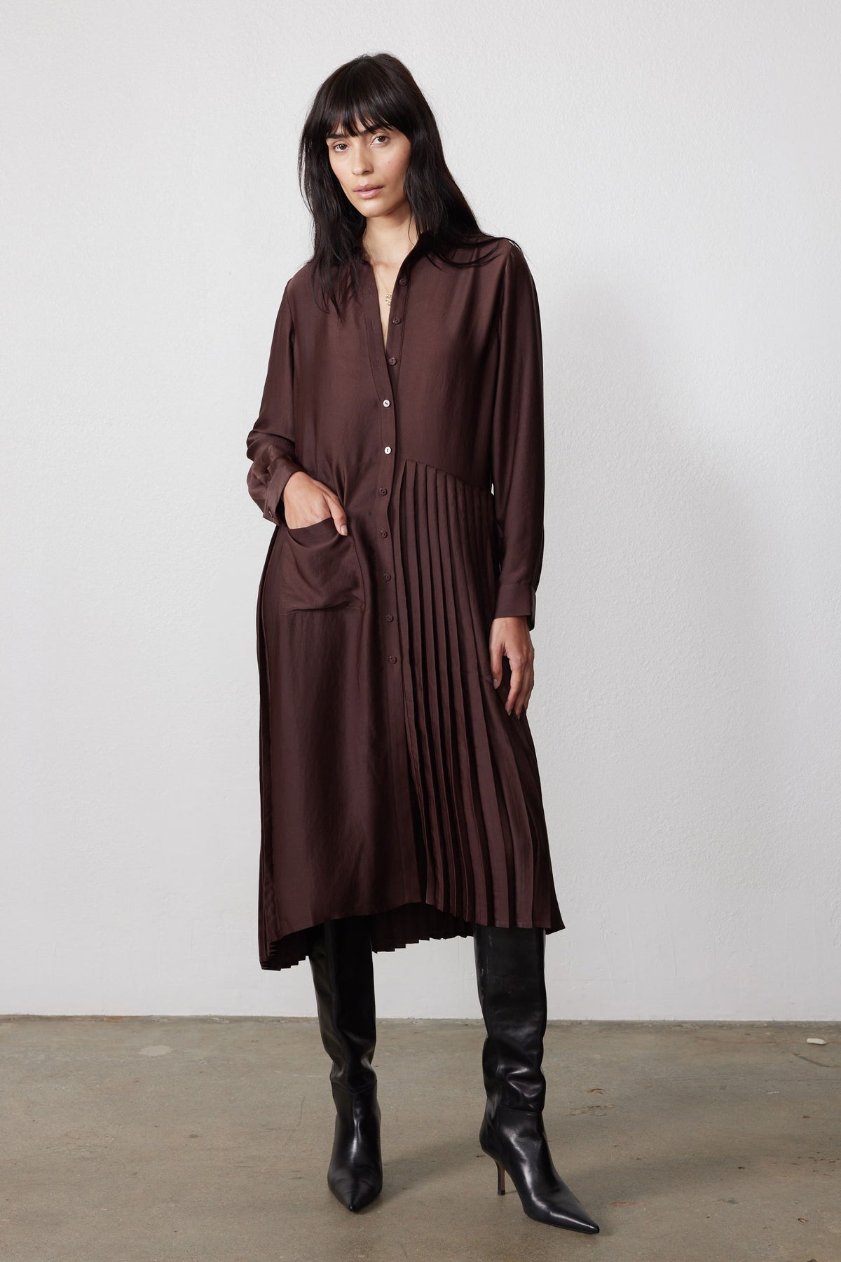 Brown long-sleeve button-front dress with one-sided pleated panel and draped side slit