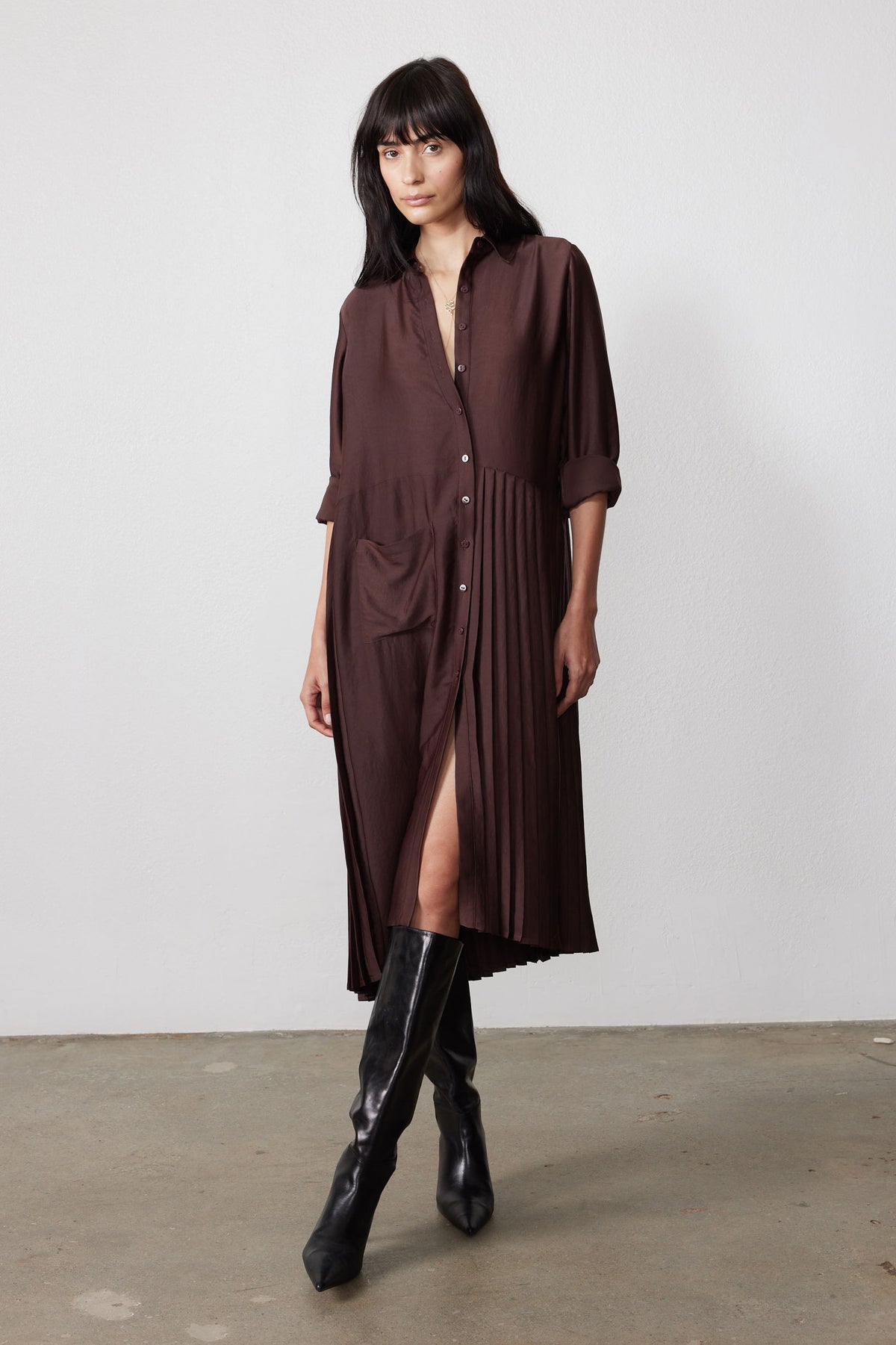 Brown long-sleeve shirt dress with button front and pleated one-sided hem detail