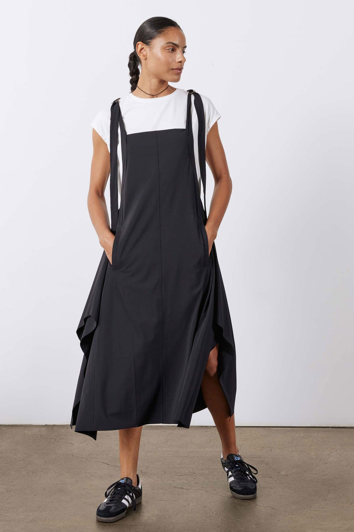 Black sleeveless sarafan dress with deep armholes and gathered skirt volume.