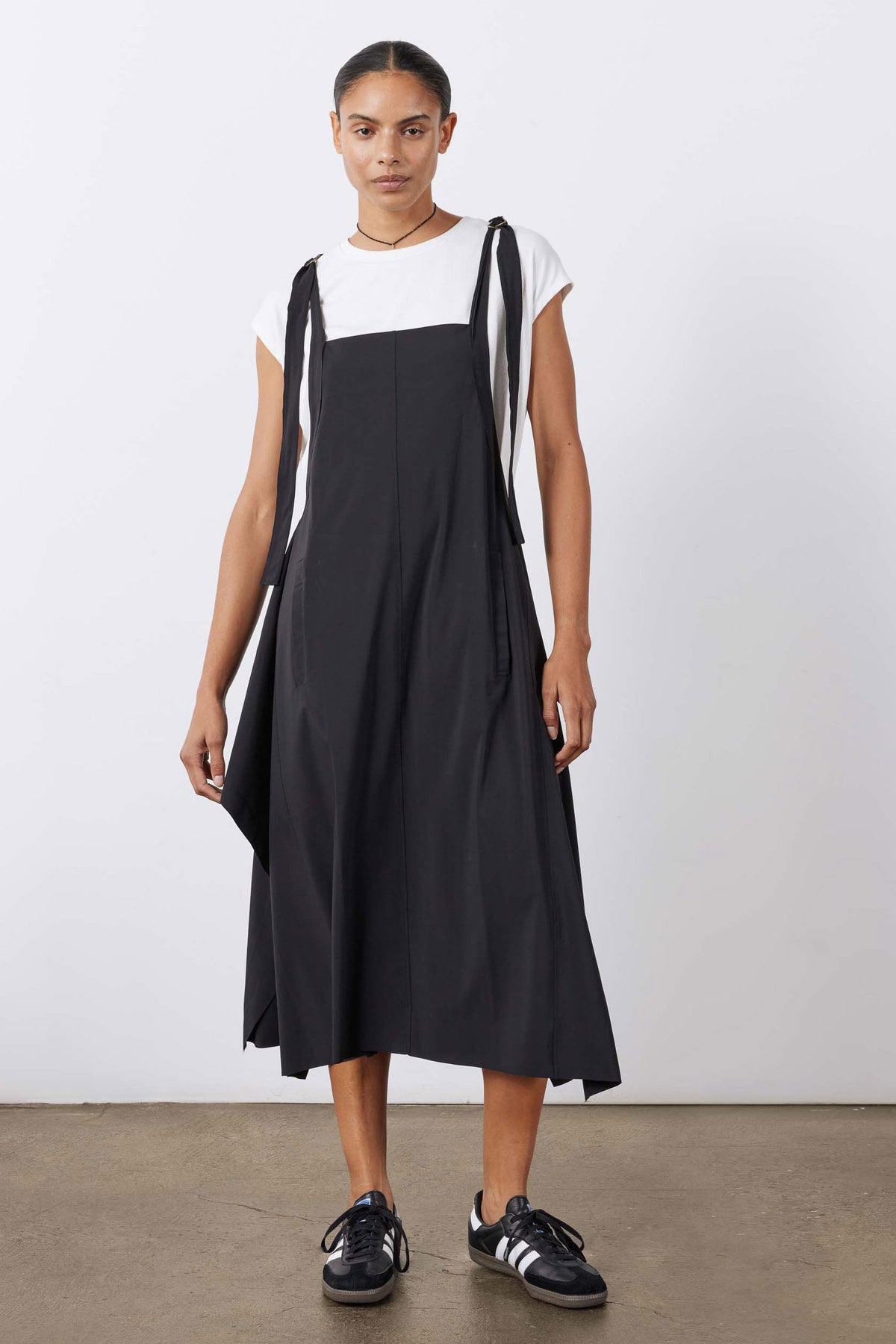 Black sleeveless midi sarafan dress with wide straps and flared hem.