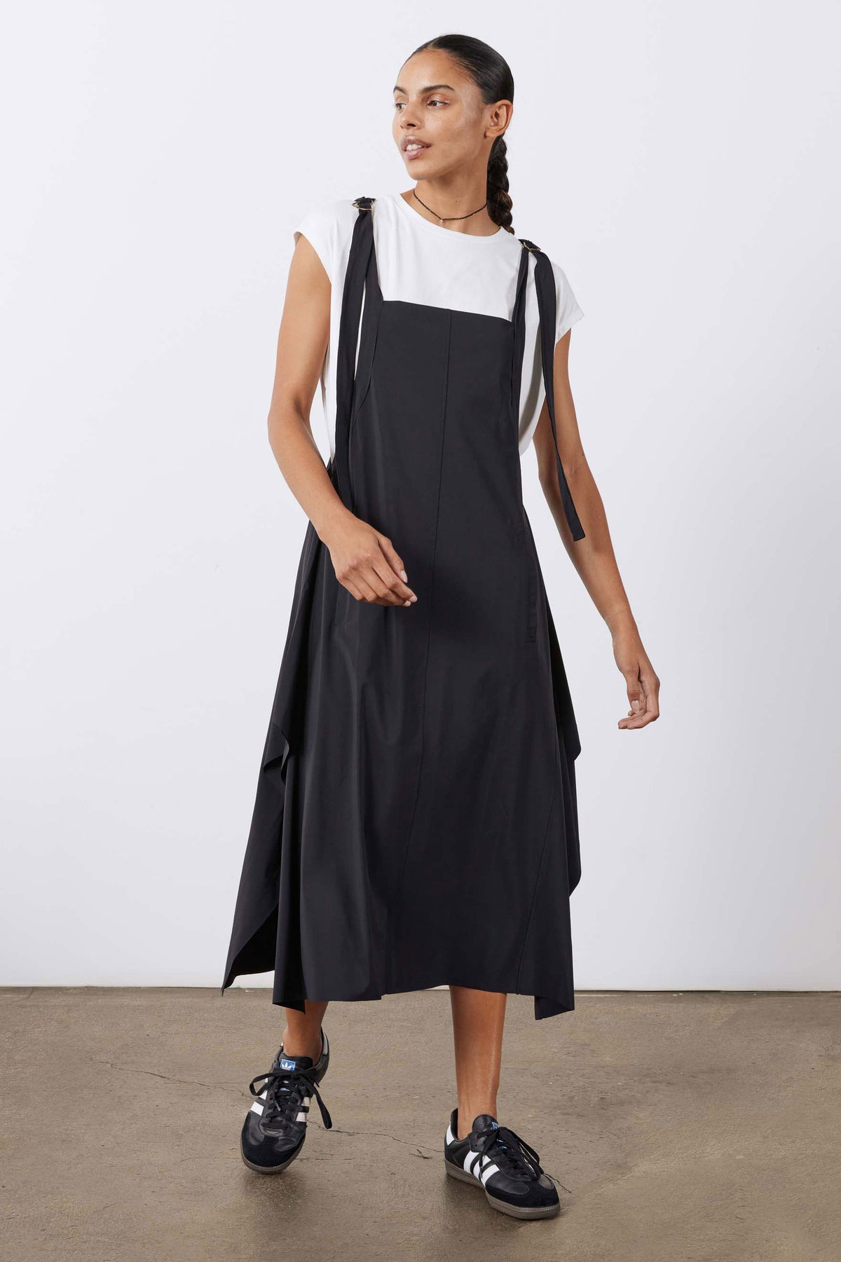 Black sleeveless midi sarafan dress with gathered front and flared skirt.