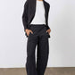 Black work pants with relaxed fit, elastic waistband, and wide leg opening, front view