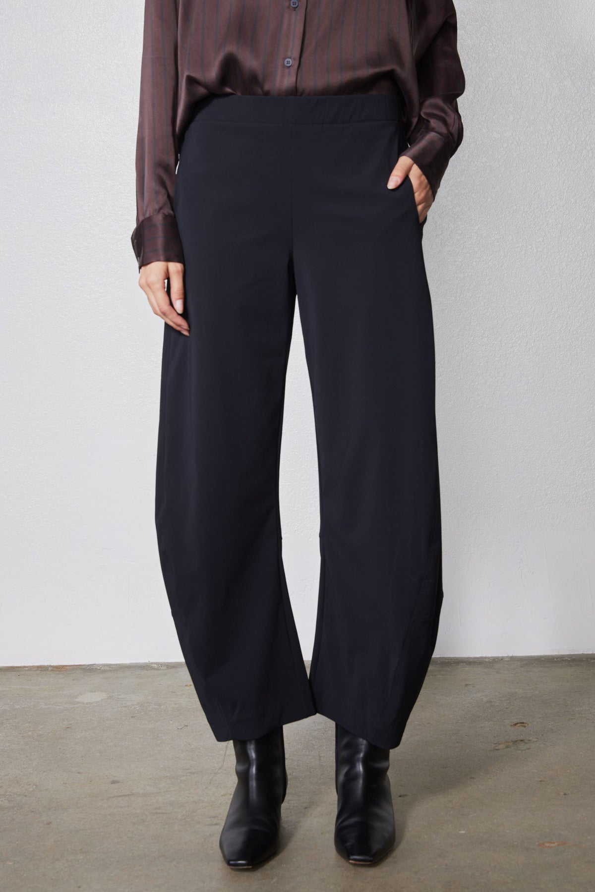 Black loose work pants with wide leg and front pleats