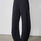 Black loose work pants with straight wide legs, back view