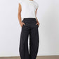 Black work pants with relaxed wide legs and elastic waistband, full-length front view