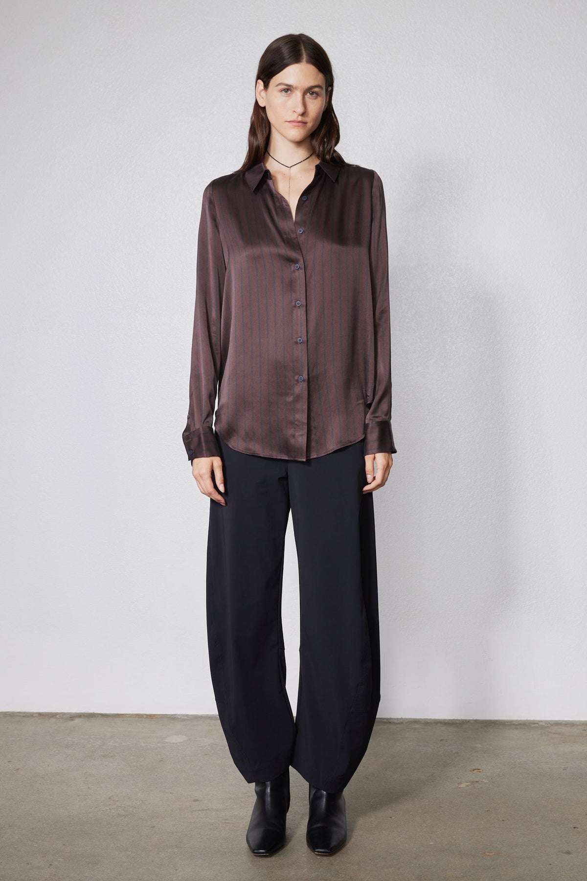Black wide-leg work pants with relaxed fit and straight leg opening