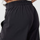 Black work pants close-up of elastic waistband and drapey fabric