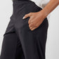 Black work pants with side pocket and elastic waistband, hand in pocket close-up