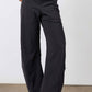 Black work pants with relaxed fit, elastic waistband, and straight wide legs, front view