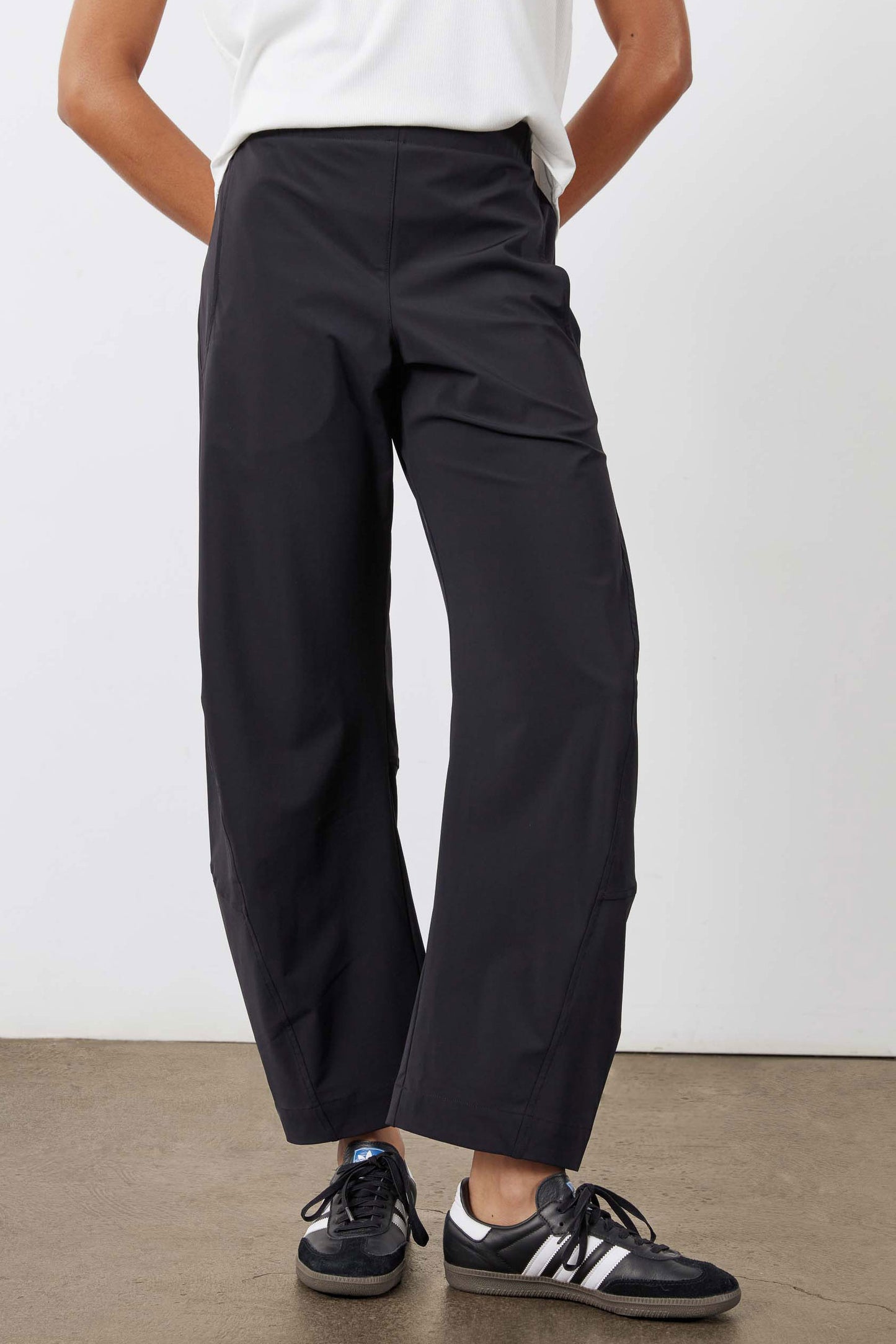 Black work pants with relaxed fit, elastic waistband, and straight wide legs, front view