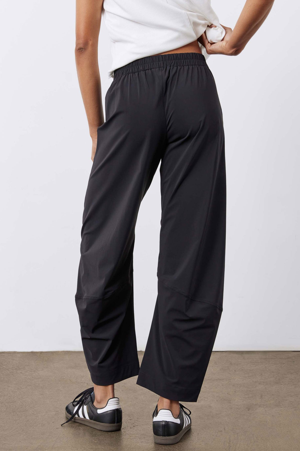 Black wide-leg work pants with elastic waist and ankle-length relaxed fit