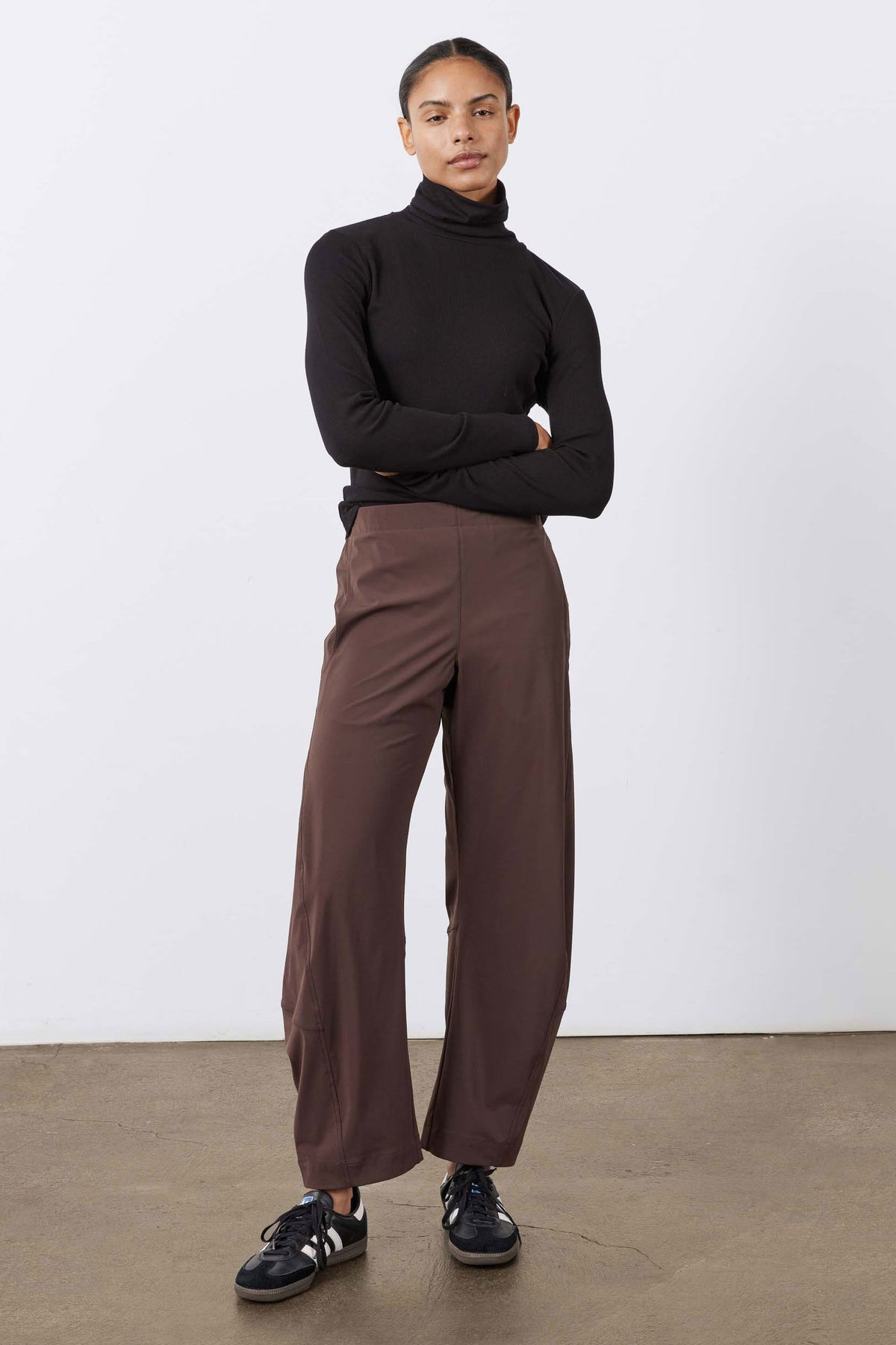 Coffee-brown wide-leg work pants with elastic waistband and relaxed straight legs.