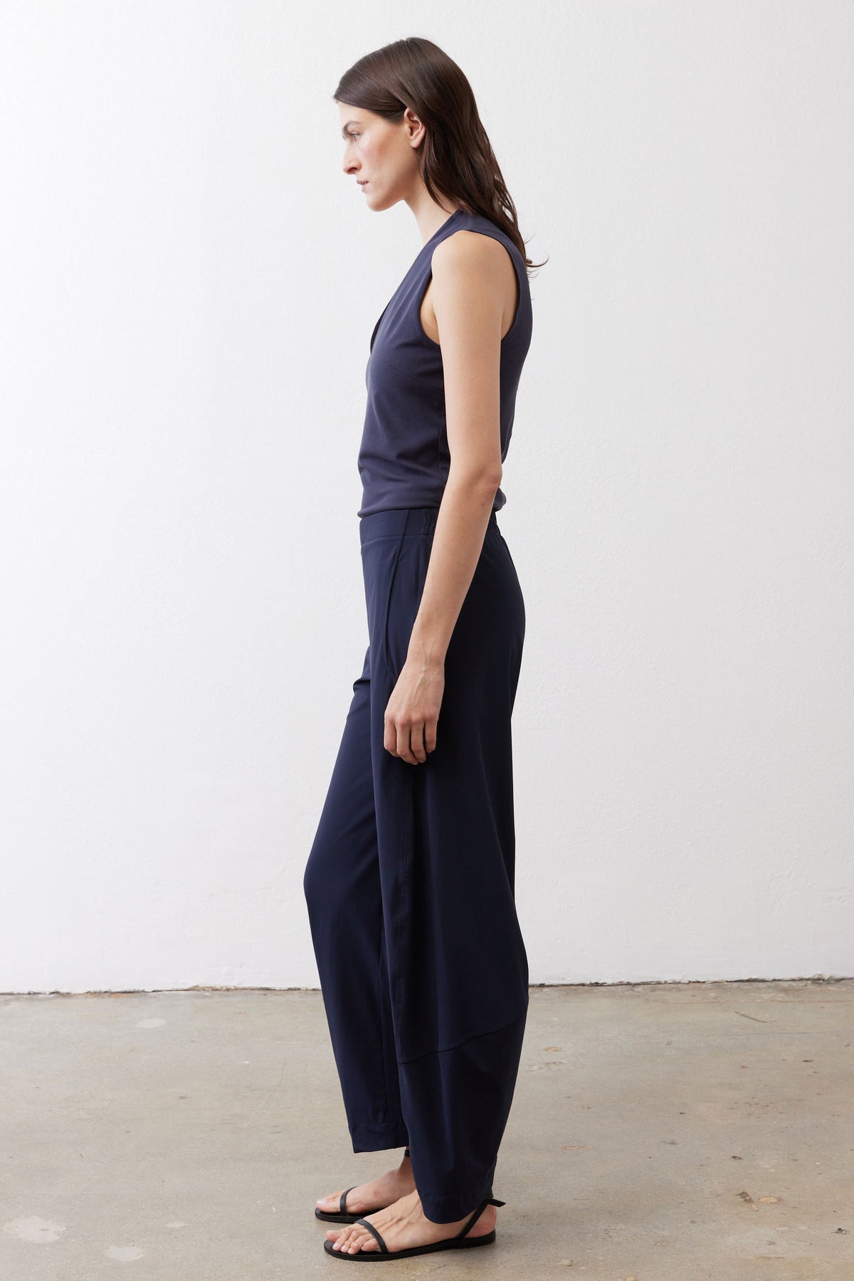 Navy loose work pants, side view with elastic waist and wide leg drape