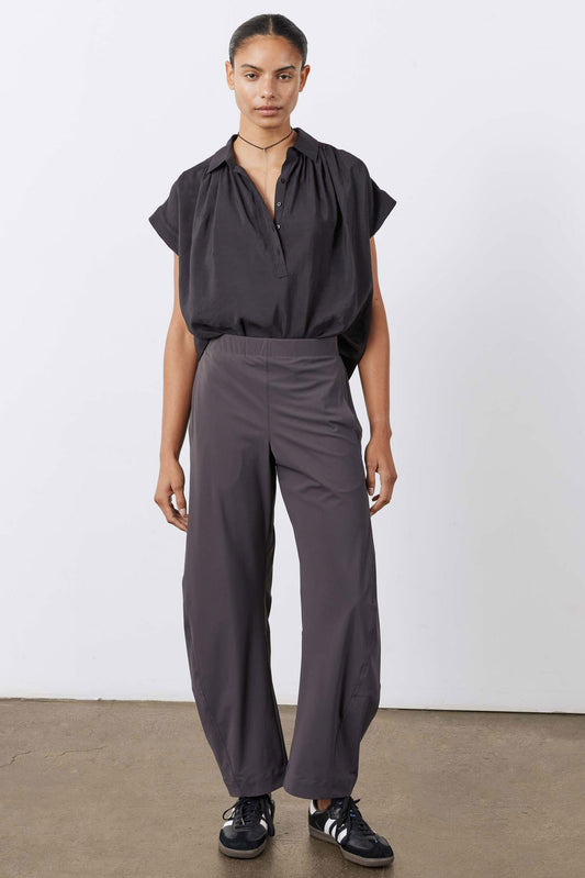 Graphite work pants on model, relaxed fit with wide legs and elastic waist