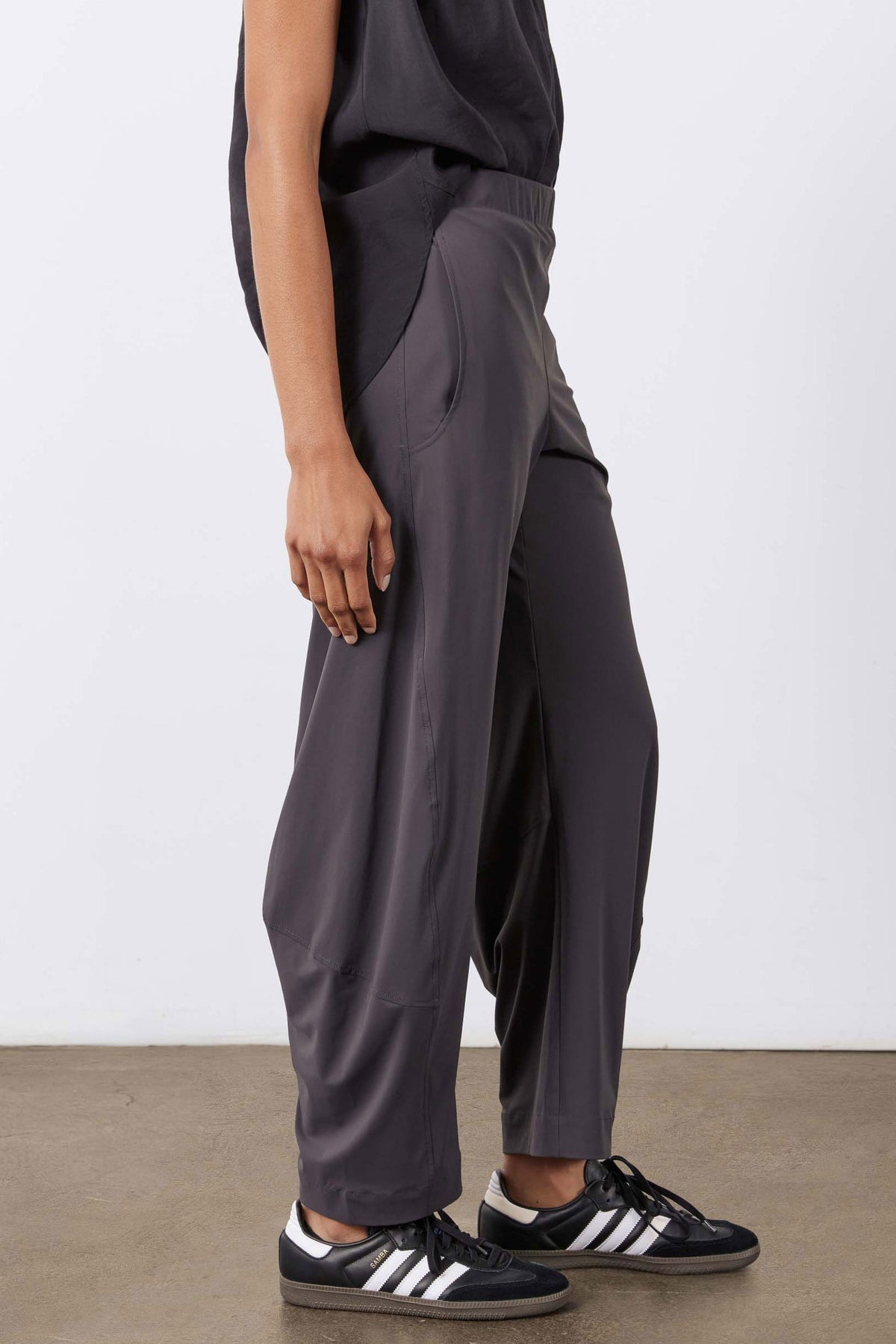 Graphite work pants side view with relaxed drape and cuffed ankle hem