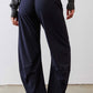 Petite dark navy work pants with elastic waist and relaxed wide legs.