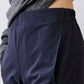 Dark navy work pants fabric close-up with elastic waistband and side seam.