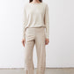 Light beige loose work pants with tapered straight legs and ankle-length hem