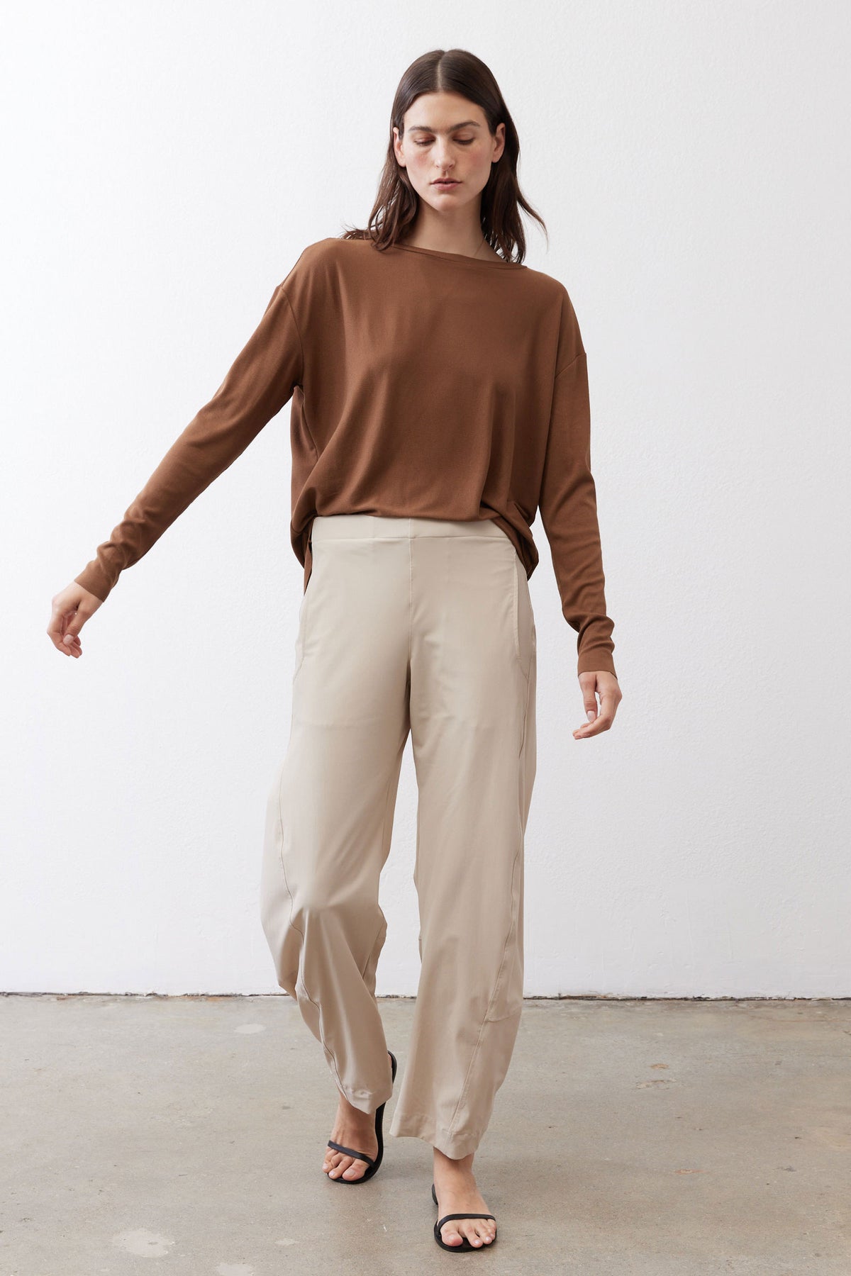 Light beige loose work pants with relaxed fit and ankle-length straight leg