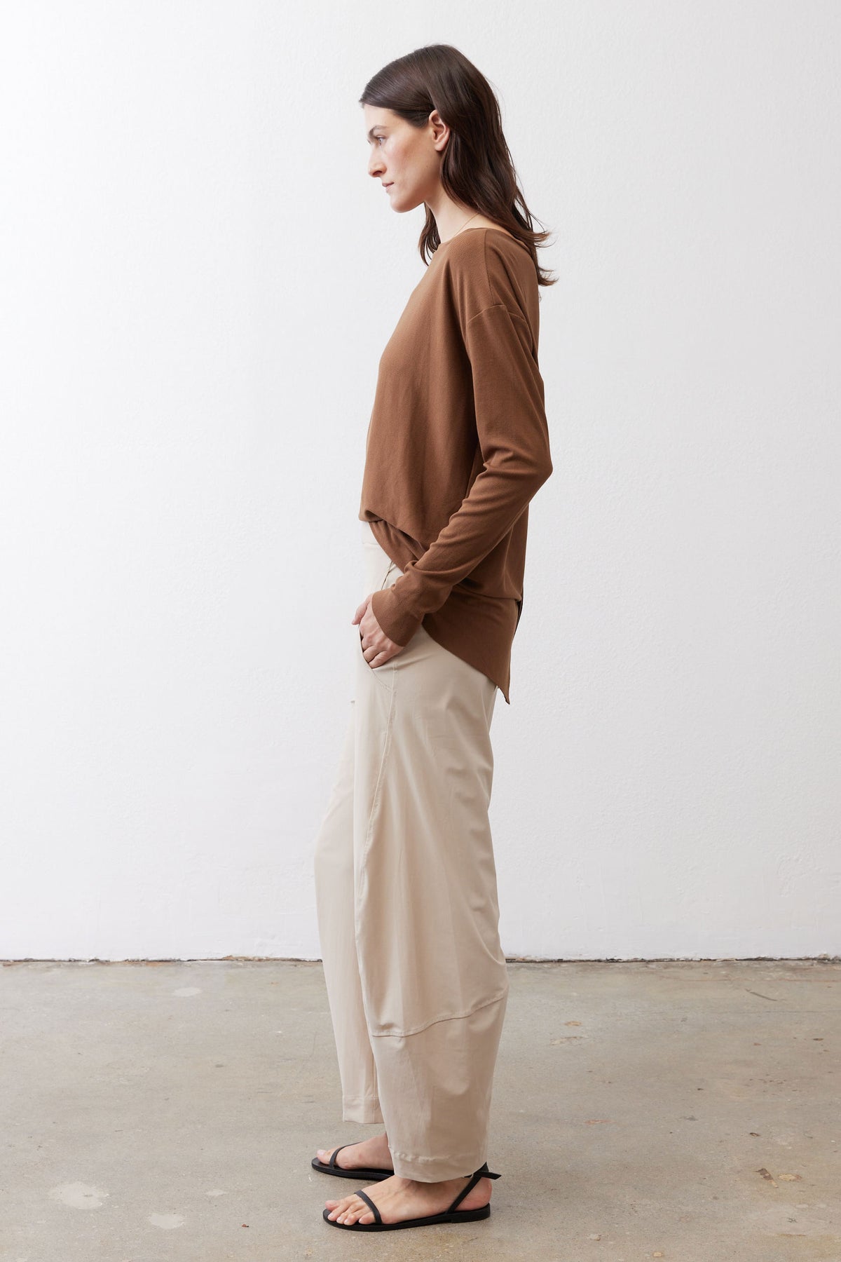 Light beige loose work pants shown from the side with relaxed straight-leg fit