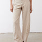 Light beige loose work pants with front slant pockets and ankle-length hem