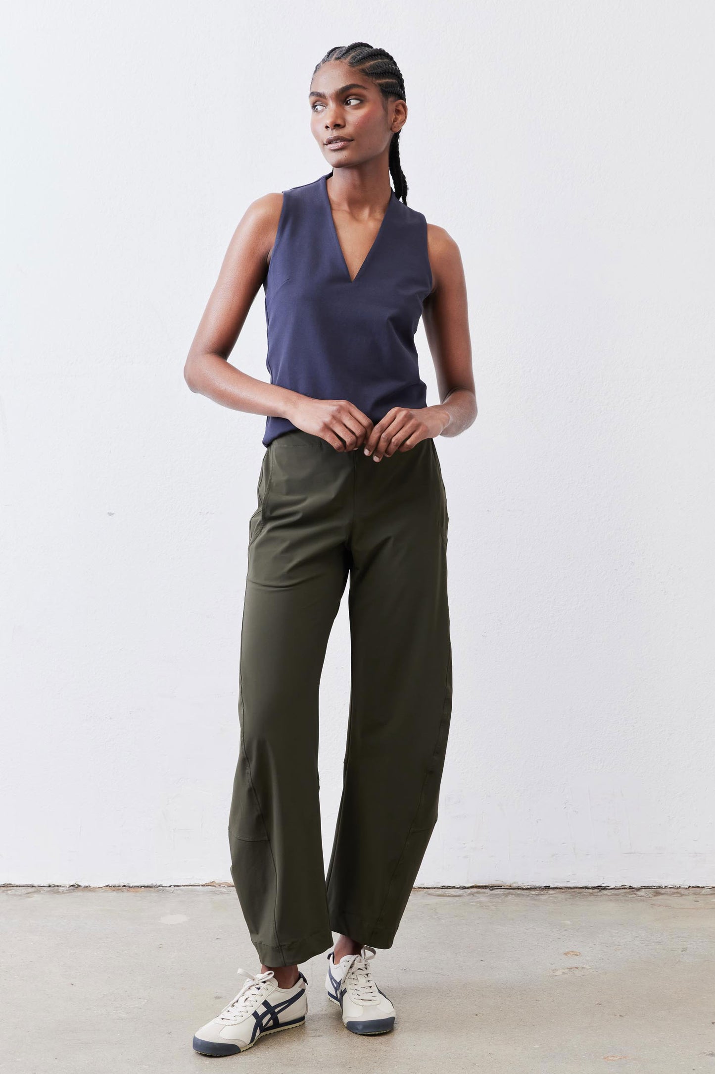 Olive work pants with loose straight legs and ankle-length hem