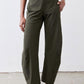 Olive green loose work pants with elastic waist and relaxed fit, rear view