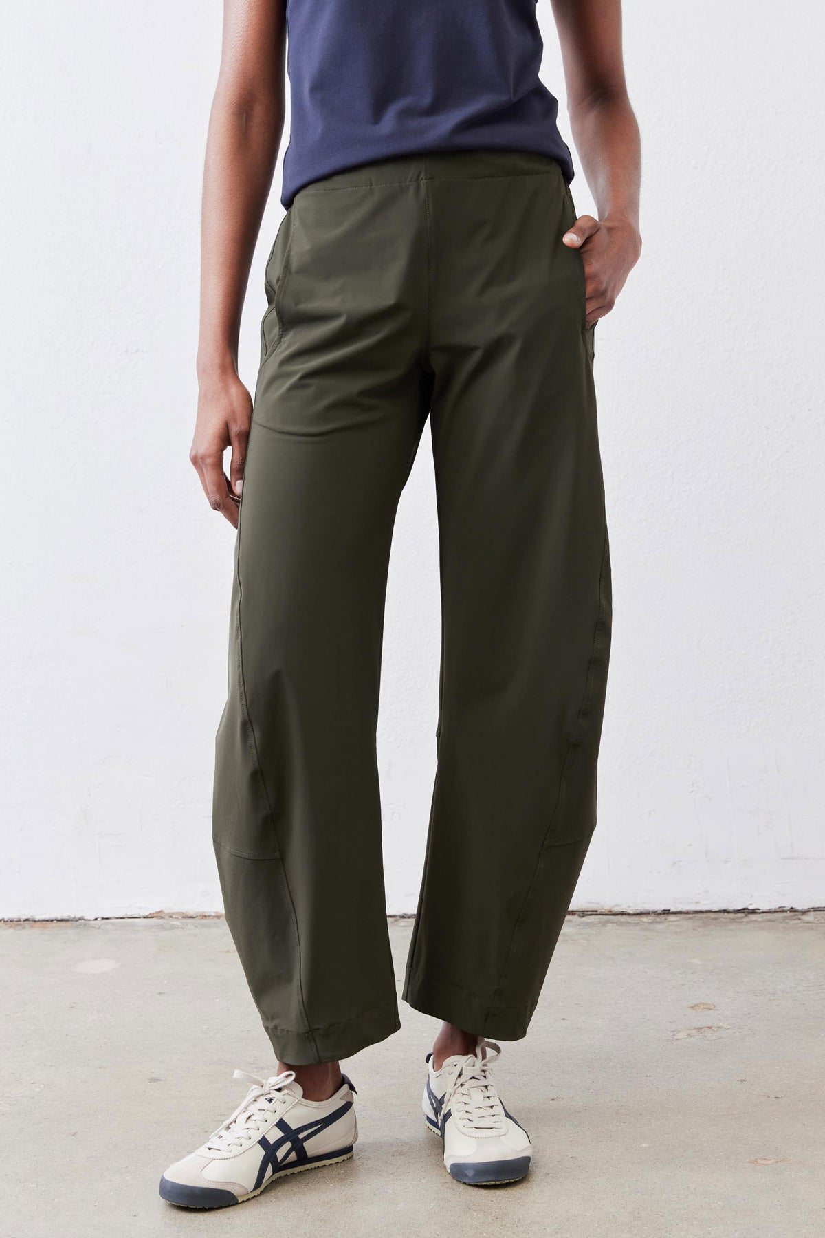 Olive green loose work pants with elastic waist and relaxed fit, rear view