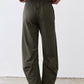 Olive green loose work pants with elastic waistband and roomy ankle-length fit