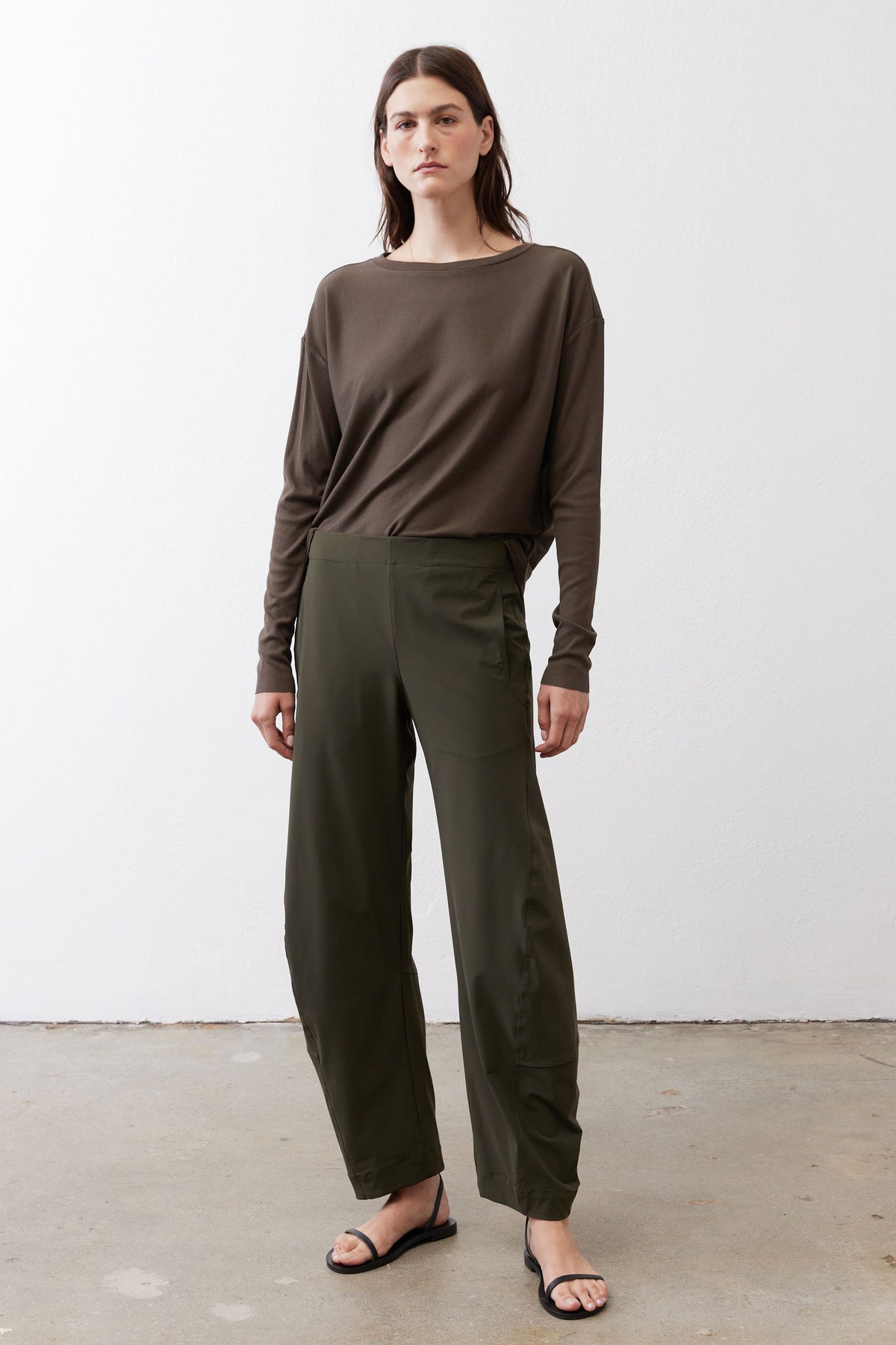 Olive green loose work pants with tapered legs and elastic waistband, full view