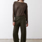 Olive green loose work pants with elastic waistband and relaxed straight-leg fit