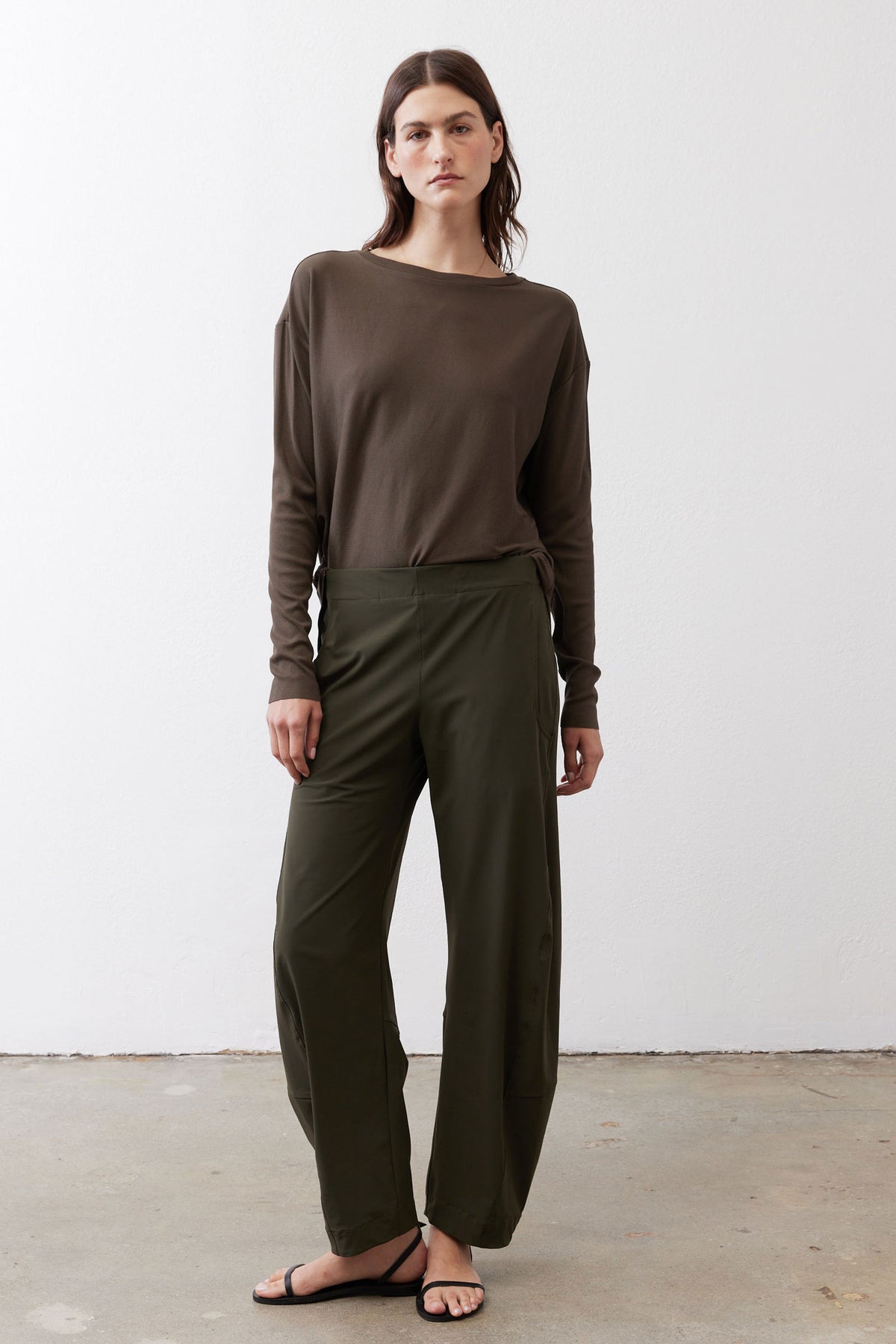 Olive green loose work pants with elastic waistband and relaxed straight-leg fit