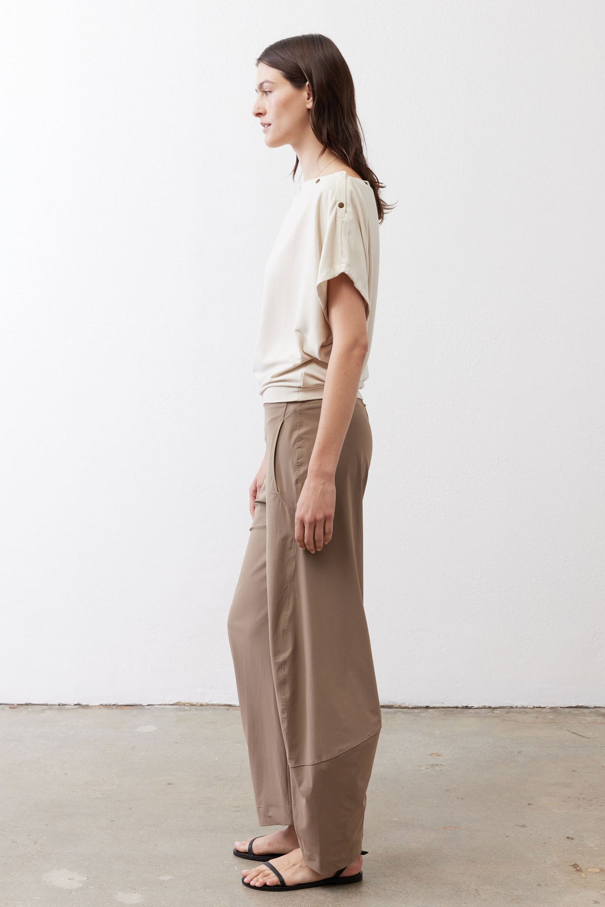 Tan relaxed work pants, side view; elastic waistband and straight tapered legs