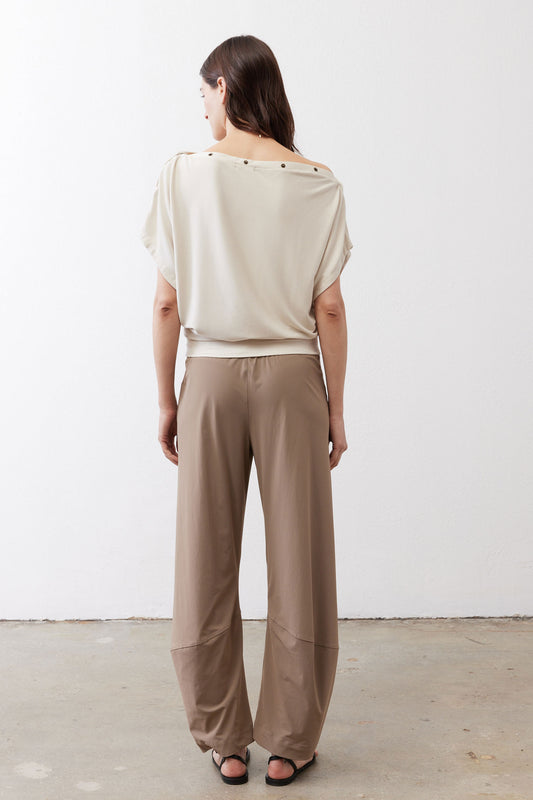 Tan work pants from back view with elastic waist and tapered ankle cuffs