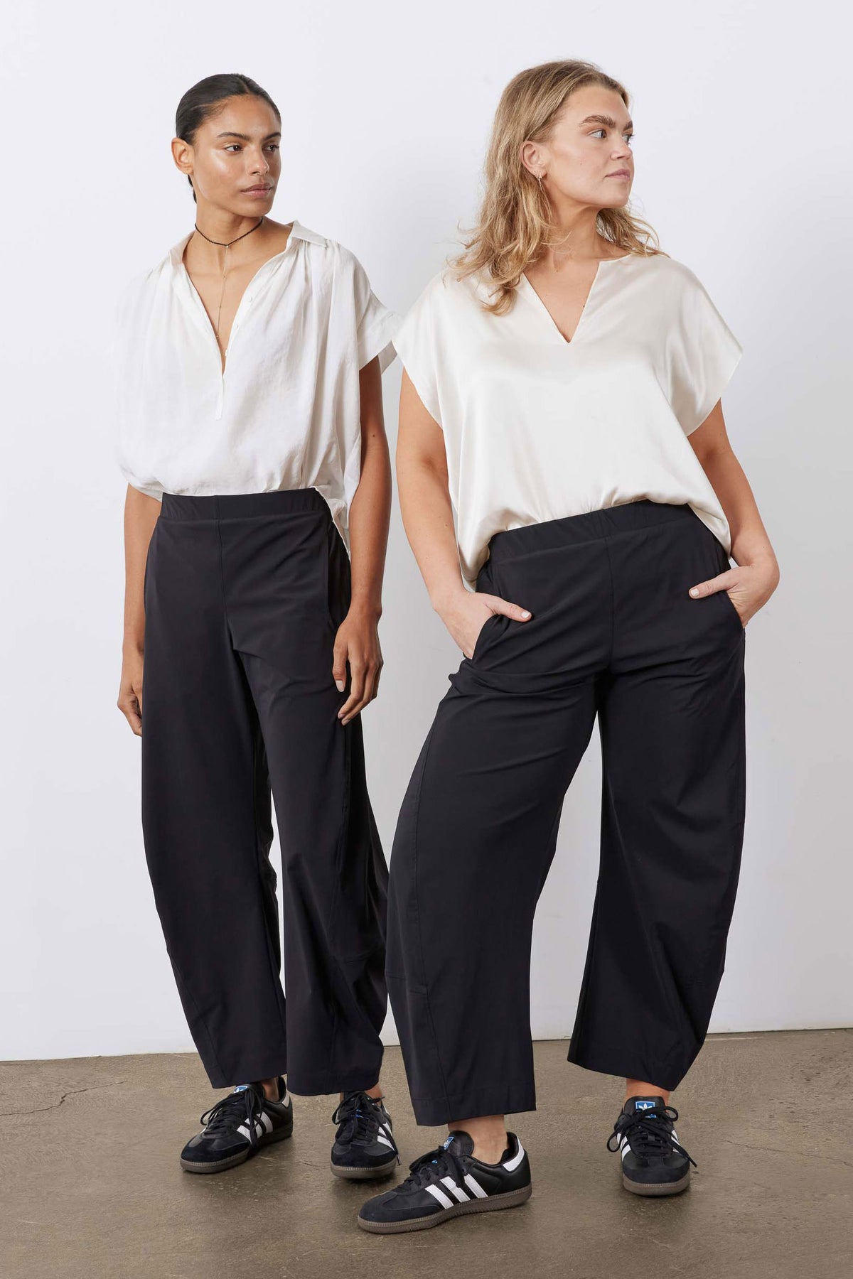 Pair of black work pants worn with sneakers; elastic waist and roomy legs
