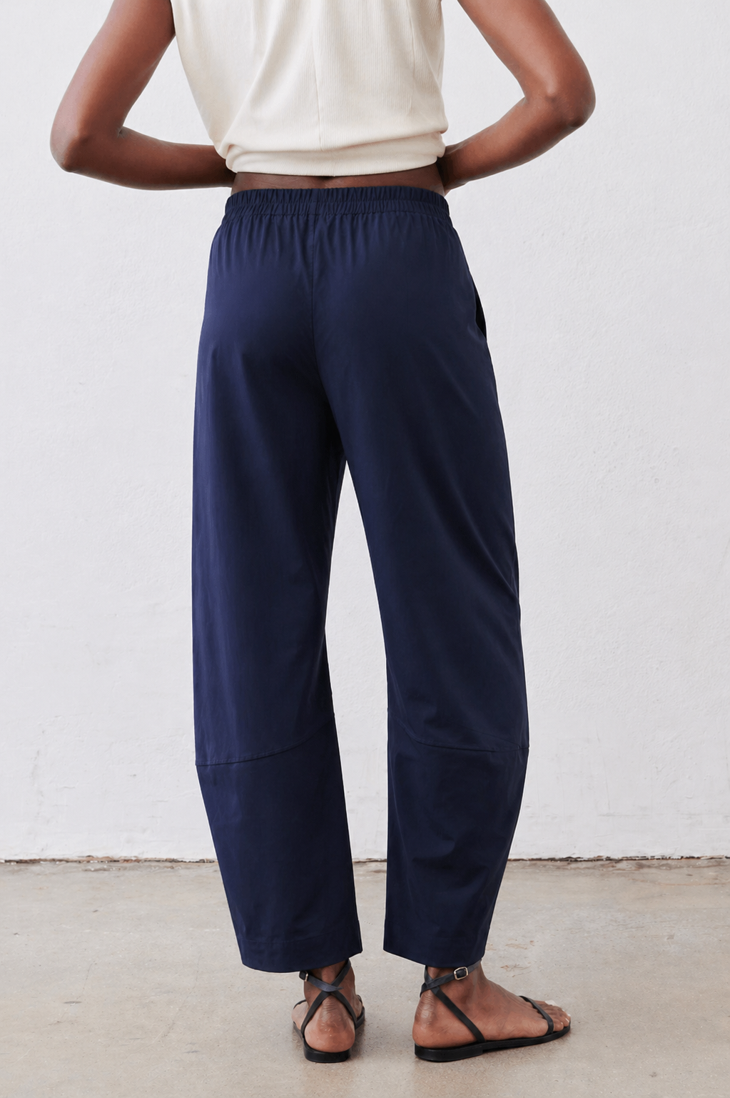 Navy loose work pants front view with elastic waist and wide legs, ankle length