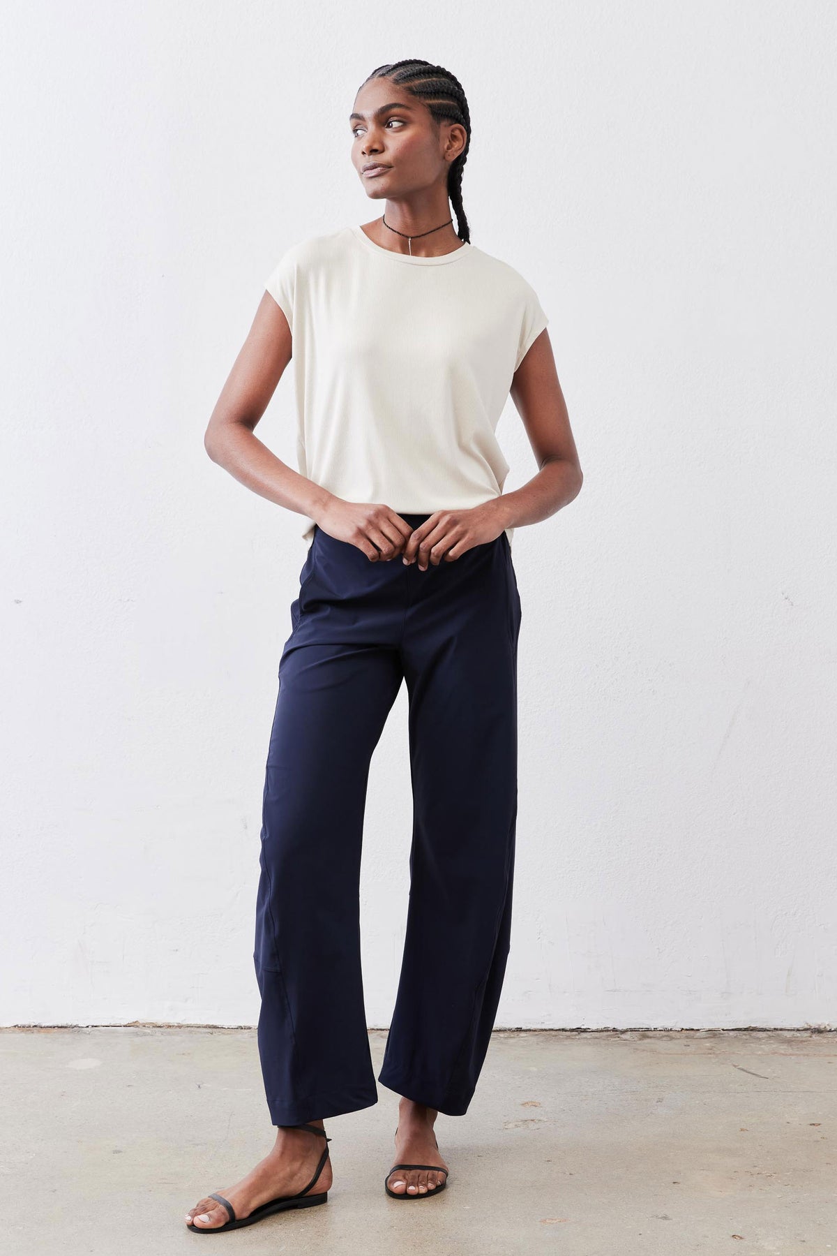Navy loose work pants with elastic waistband and wide straight legs, cropped at ankle