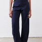 Close-up of navy work pants with elastic waistband and relaxed wide-leg silhouette