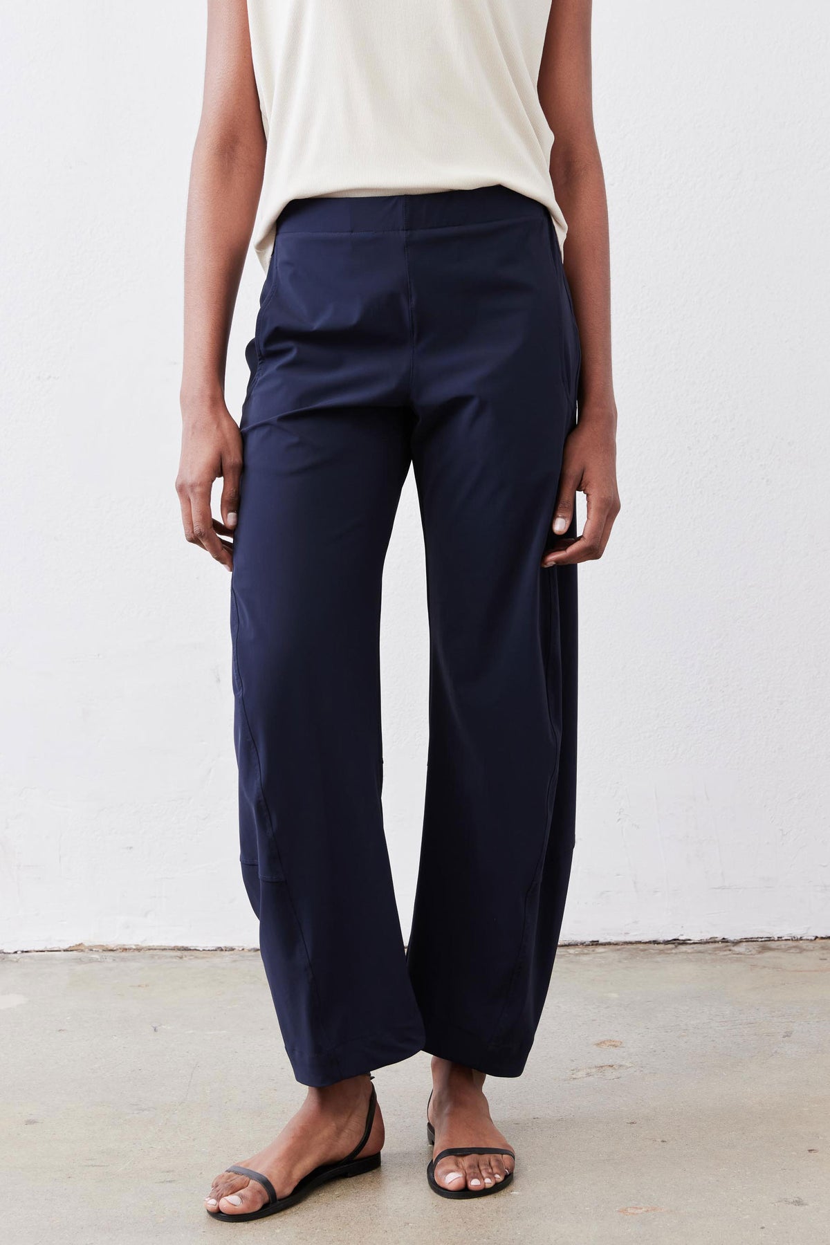Close-up of navy work pants with elastic waistband and relaxed wide-leg silhouette