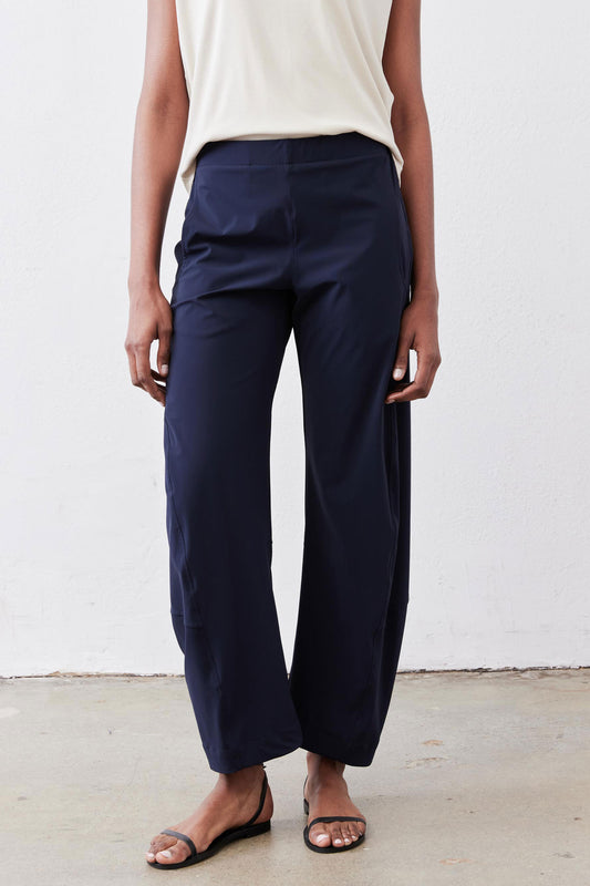 Close-up of navy work pants with elastic waistband and relaxed wide-leg silhouette