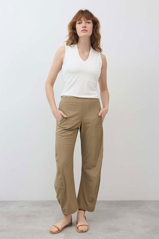 Relaxed tan work pants with elastic waistband and ankle-length straight legs.